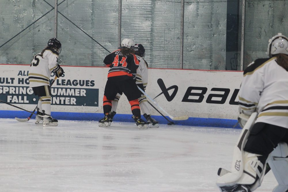 Scrum along the boards with HB's goalie watching.