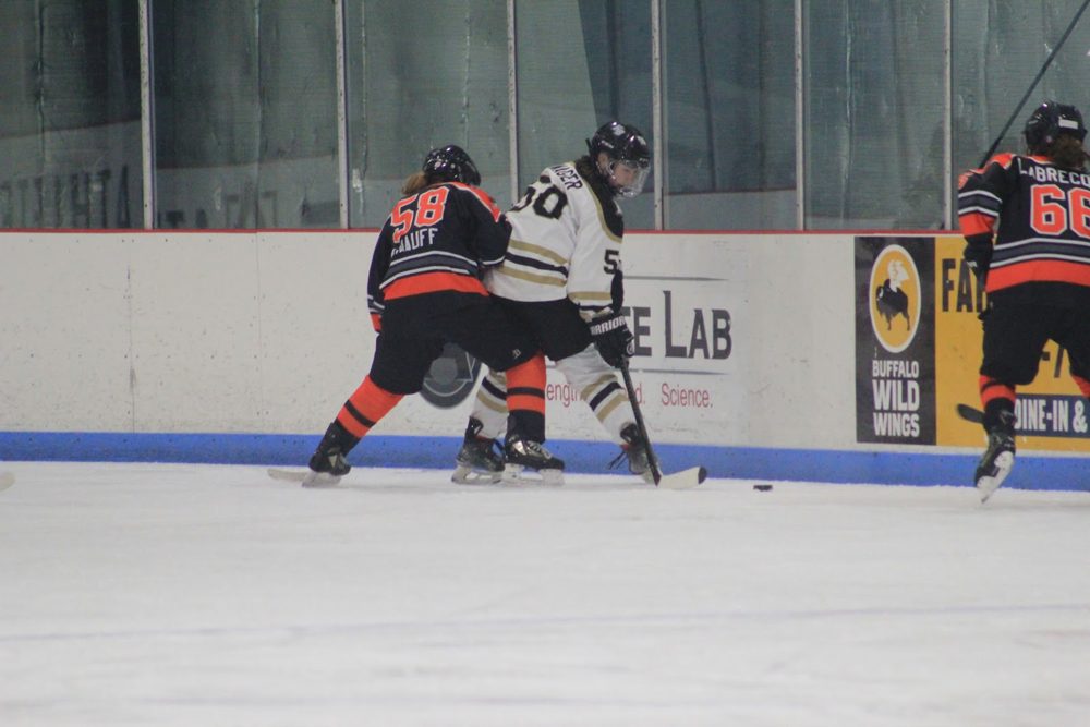Rachael K. (#58) and Claire L. (#66) pinch along the wall.