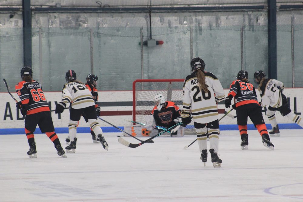 Scramble around the crease with Claire L. (#66) closing in.