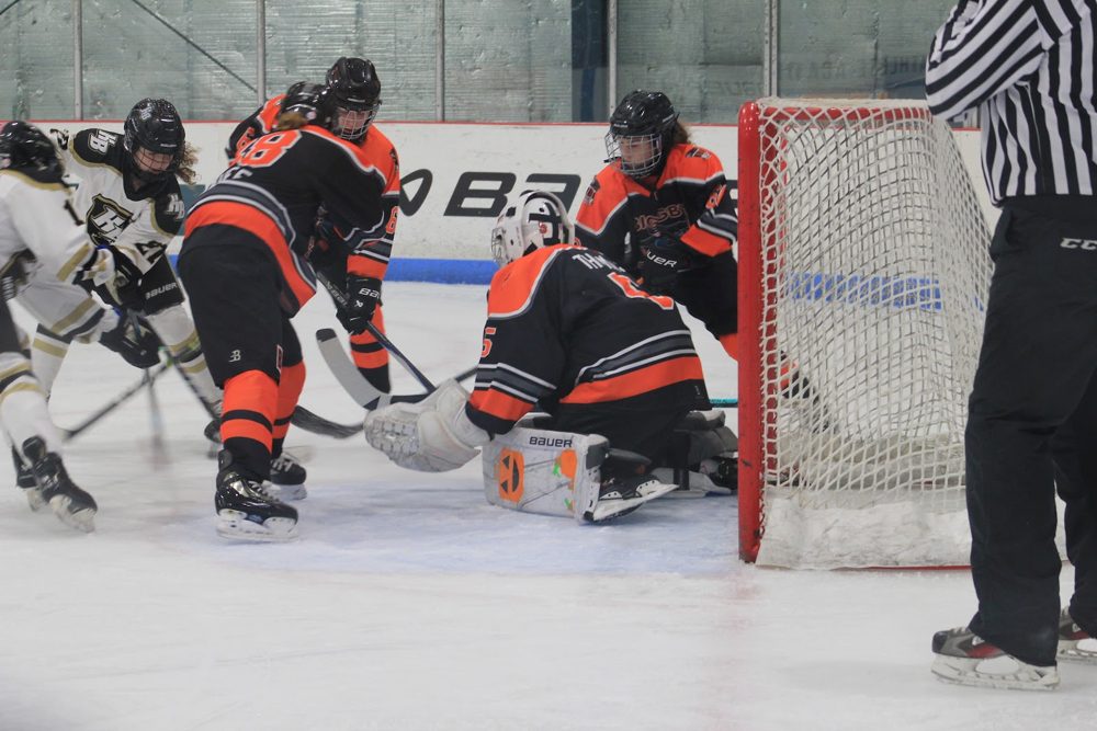 Makayla T. (#5) fights through traffic in her crease.