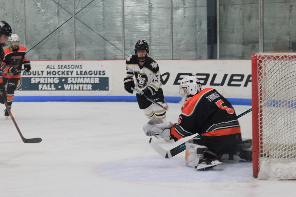 Makayla T. (#5) tracks the shot, HB forward in tight.