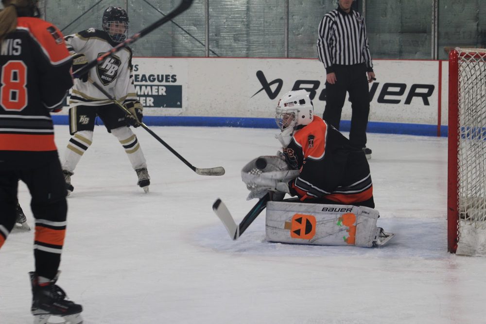 Makayla T. (#5) down in the butterfly as HB drives the net.
