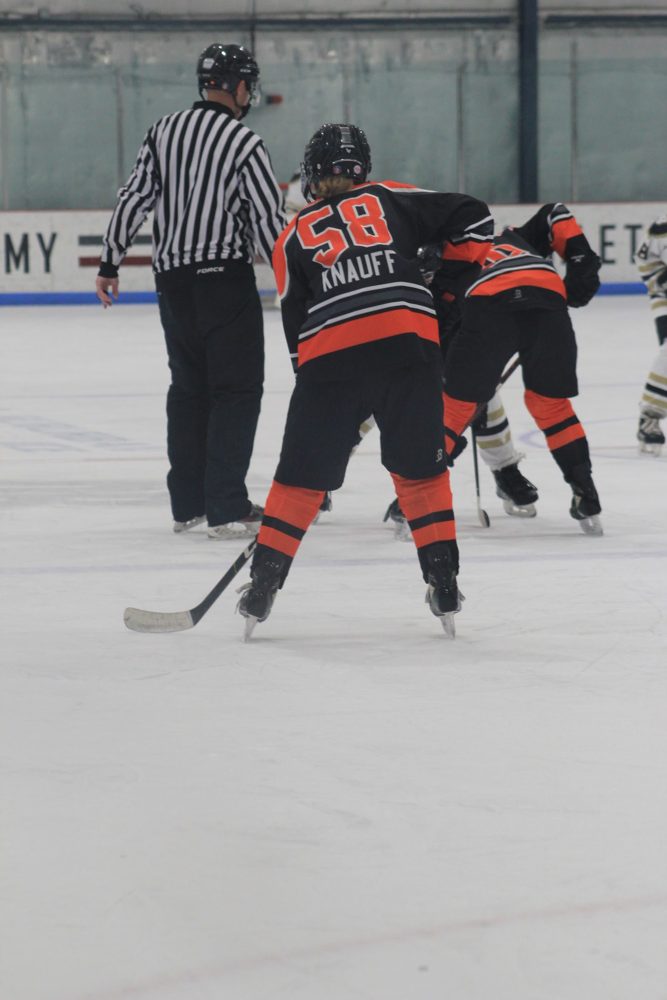Rachael K. (#58) in the faceoff circle.