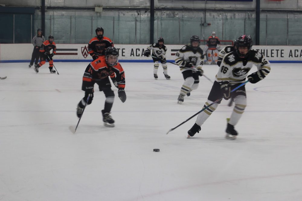 Bomber in the neutral zone with an HB skater alongside.