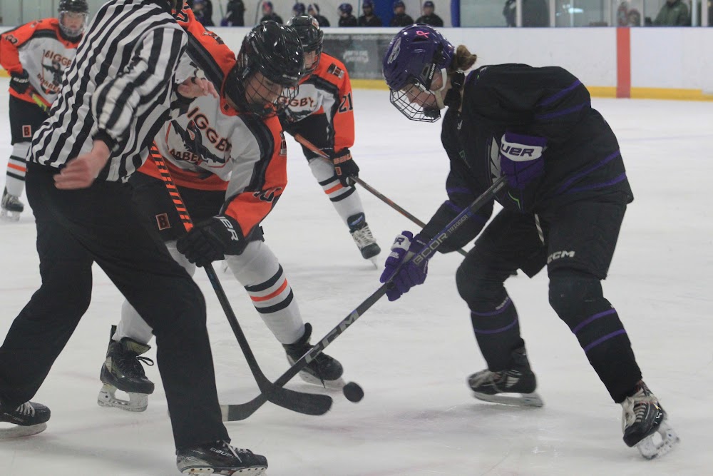 Faceoff battle, with Julia C. (#21) set up behind the draw.