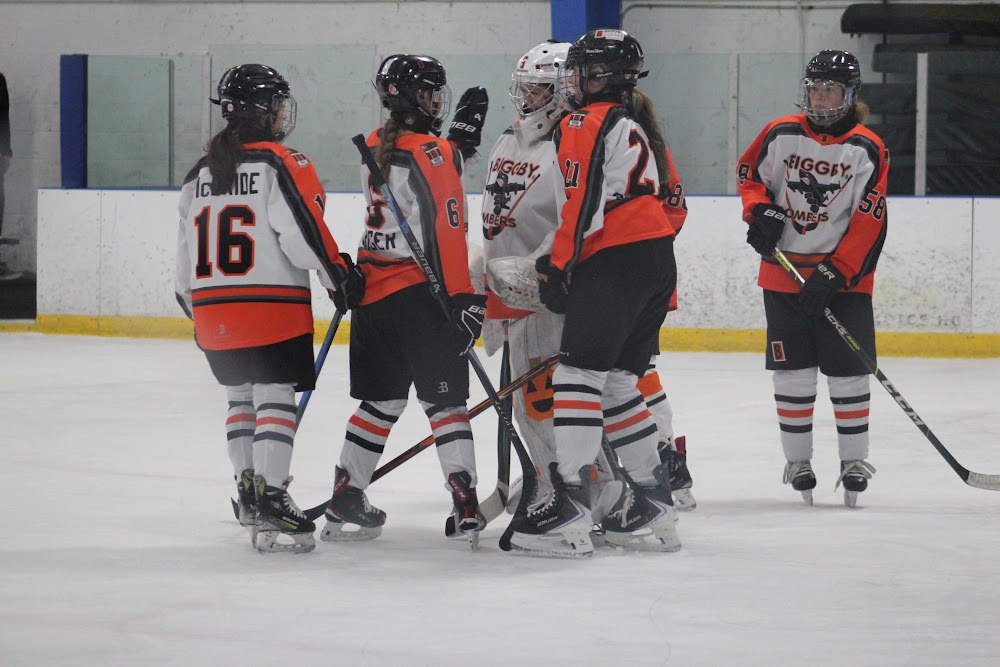Pre-faceoff huddle: Kaylee M. (#16), Violet G. (#6), Julia C. (#21) and Rachael K. (#58).