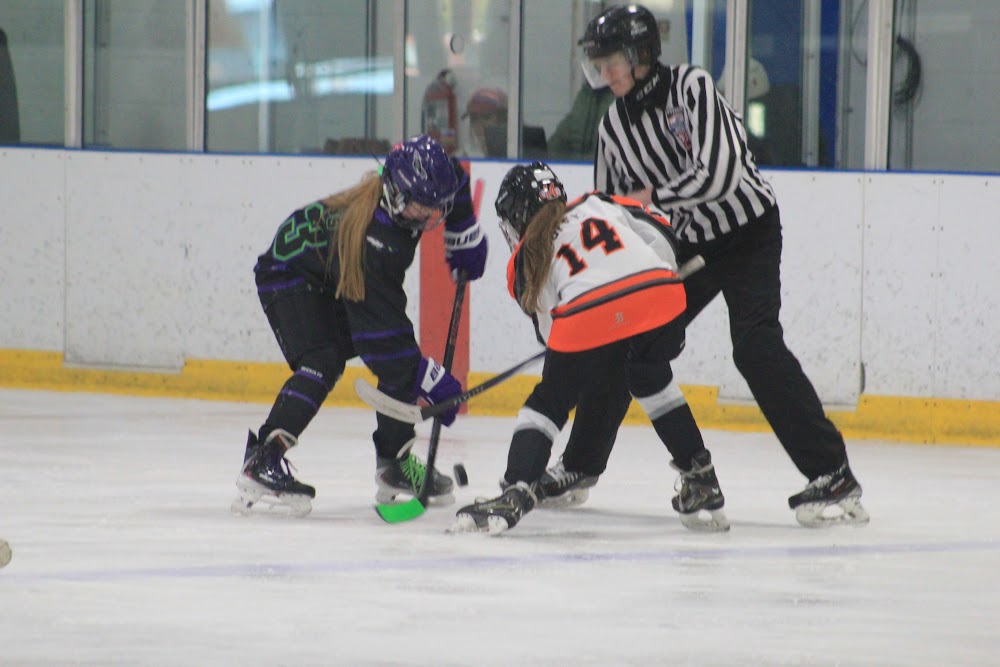 Emma J. (#14) squares up for the faceoff.